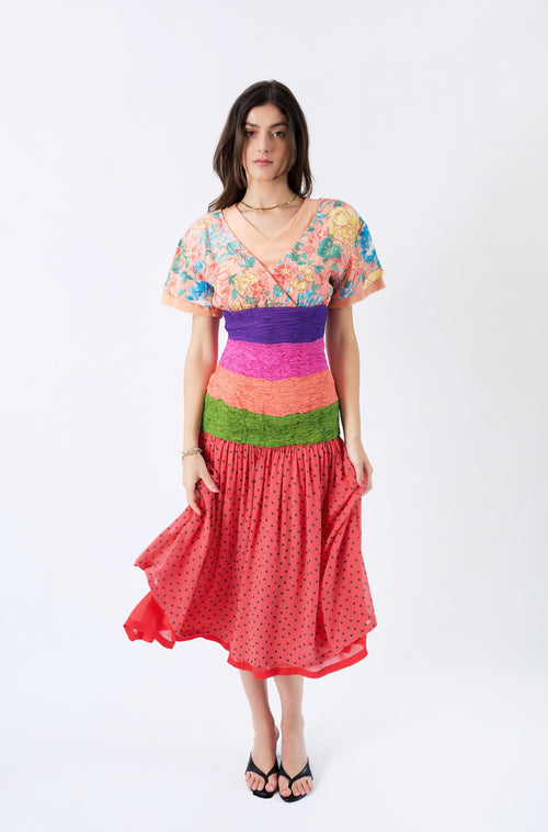 Valentino S/S 1989 runway floral silk dress shown from the front, with a V-neck floral bodice, multicolour pleated waist and polka-dot skirt; Josie Borain campaign and Marpessa Hennink runway reference.