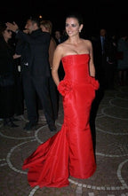 Naomi Campbell wearing the Valentino F/W 2004 red taffeta rosette gown; Runway Look #53 reference, also worn by Penelope Cruz and featured in The Devil Wears Prada.