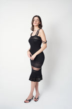 John Galliano SS1998 black pointelle knit dress — side view showing elongated silhouette and mesh transition