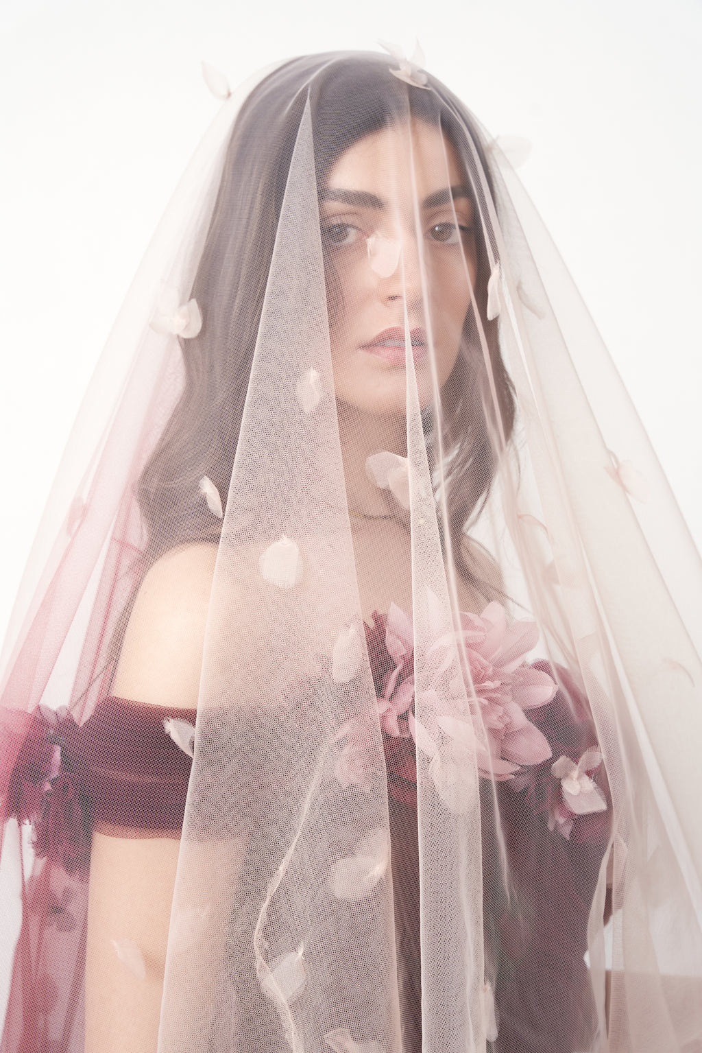 Marchesa 2018 — tulle train styled as veil over model's head, showing scattered petal appliqués BRIDAL look
