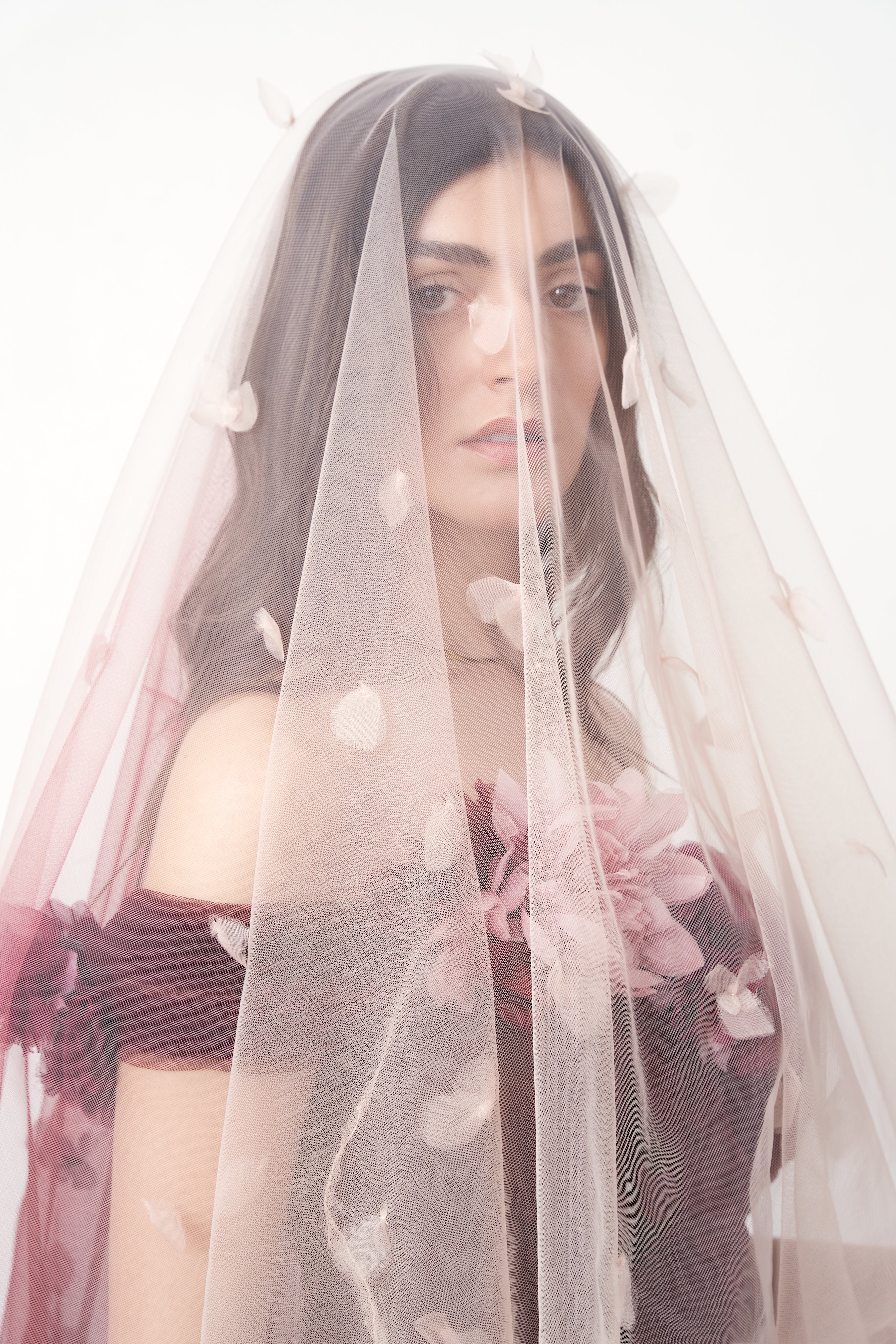 Marchesa 2018 — tulle train styled as veil over model's head, showing scattered petal appliqués BRIDAL look