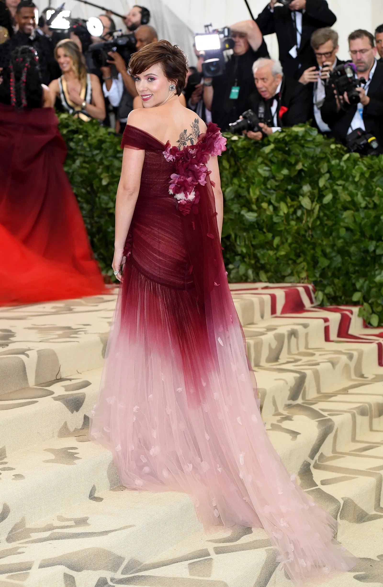 Marchesa 2018 Met Gala Scarlett Johansson on stairs. Ombre tulle gown with floral applique